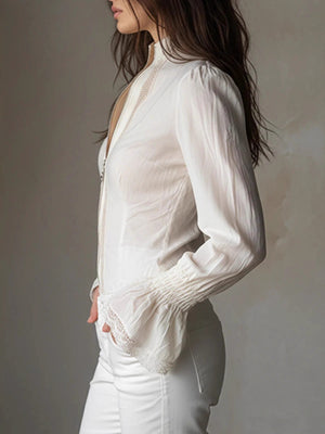 White lace trim stand-up collar shirt with bell cuffs and a zip front.