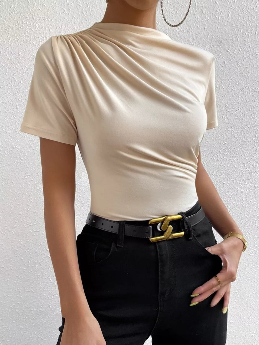 Apricot ruched mock neck t-shirt with short sleeves and draped detailing.