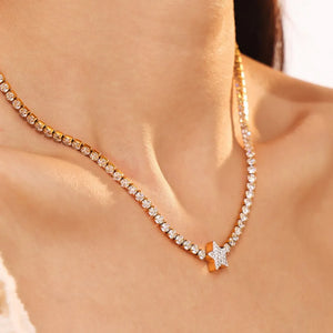 Gold choker necklace with pavé starburst pendant and crystal accents.