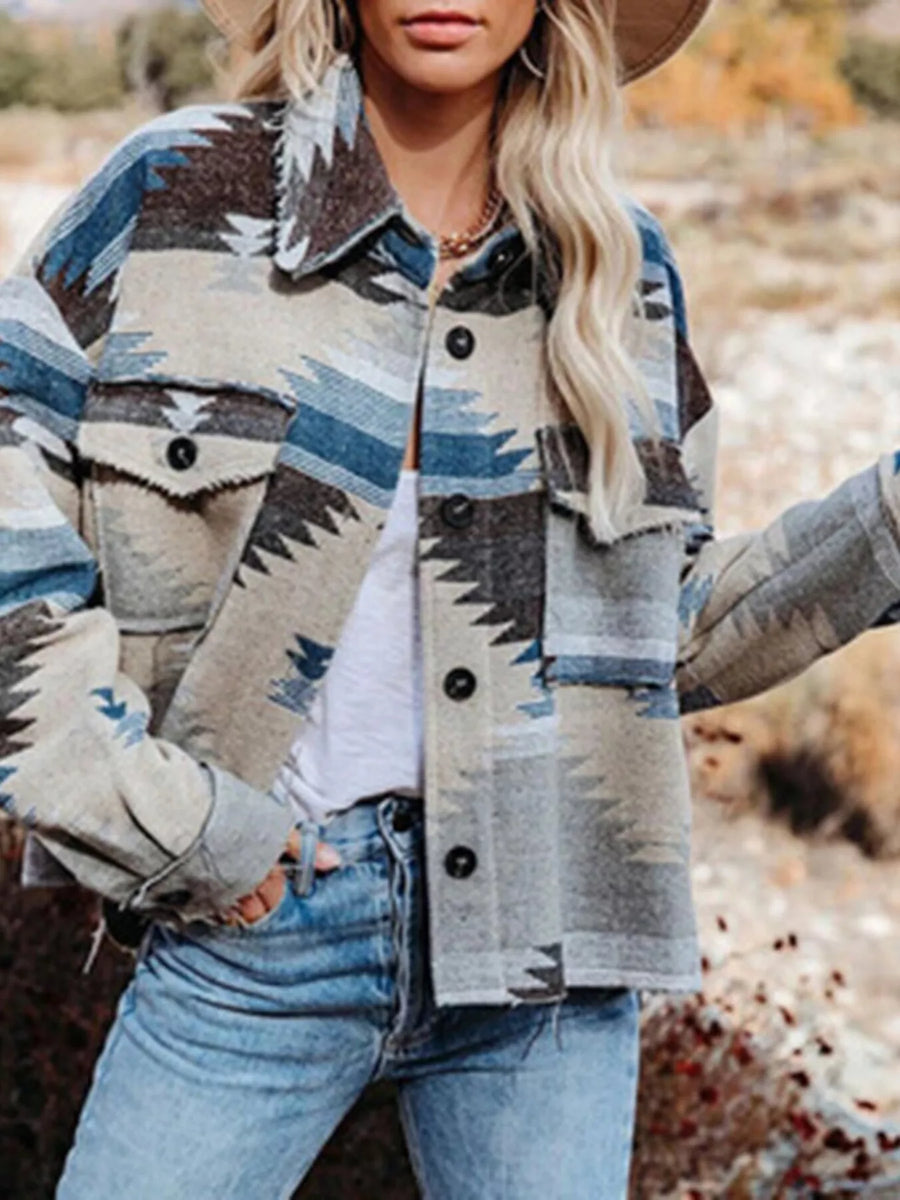 Geometric button-up jacket in Peacock Blue with frayed details and chest pockets.