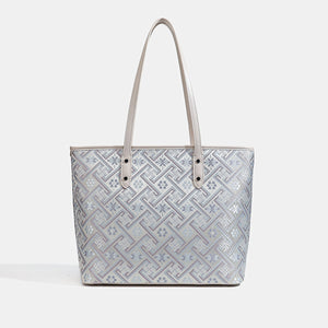 pale lavender tote featuring tassel charm and geometric