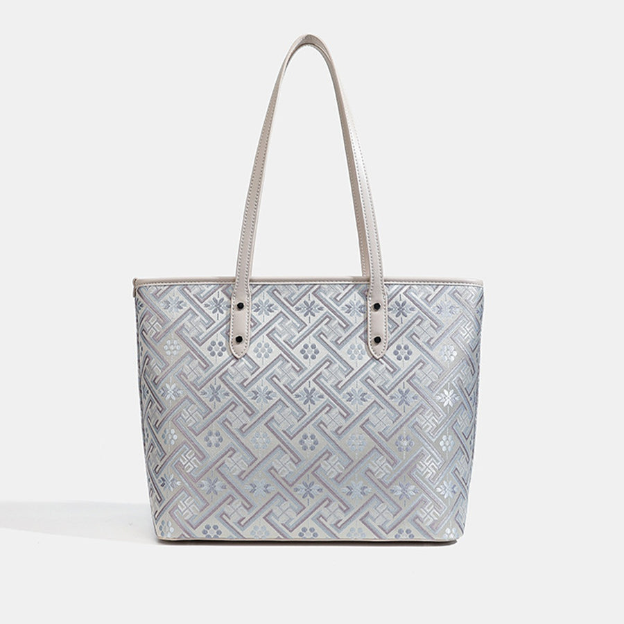 pale lavender tote featuring tassel charm and geometric