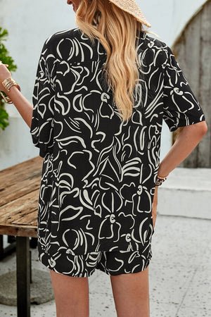 Black abstract print resort shirt with short sleeves and button-down style.