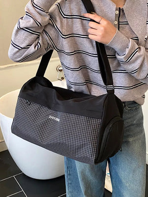 Black travel organizer bag with a subtle grid pattern and white text detail.
