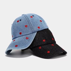 white cap featuring embroidered and heart