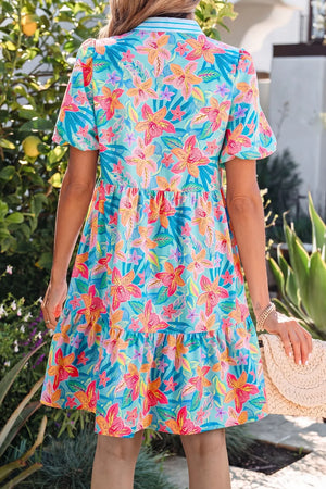 Tropical floral print tiered mini dress with short sleeves and a scalloped hem.