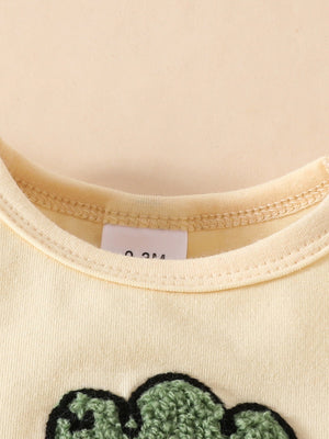 Baby yellow t-shirt with green carrot applique and ruffled neckline detail