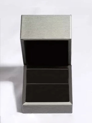 Silver ring box with open lid and dark interior