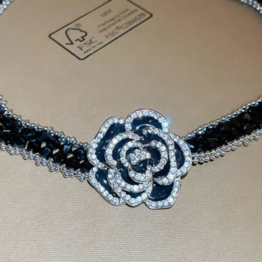 Black crystal rose choker necklace with silver trim and black enamel rose with crystal accents.