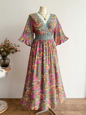 Maxi dress with floral print, lace trim, and surplice neckline.