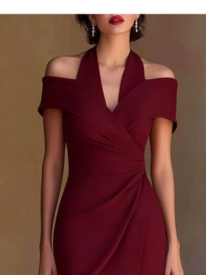 Sophisticated red asymmetrical midi dress with off-shoulder neckline and draped detail.
