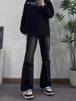 Men's dark wash cotton flare jeans with pockets, styled with a black sweatshirt and sneakers.