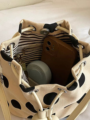 White crossbody bag with drawstring and polka dot