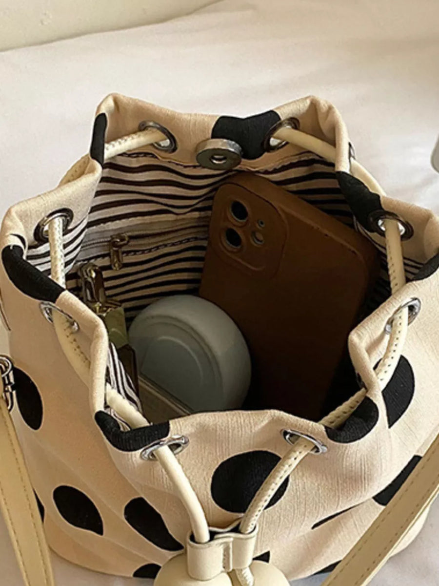 White crossbody bag with drawstring and polka dot