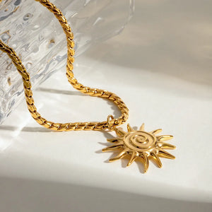 Gold necklace featuring adjustable chain and sunburst