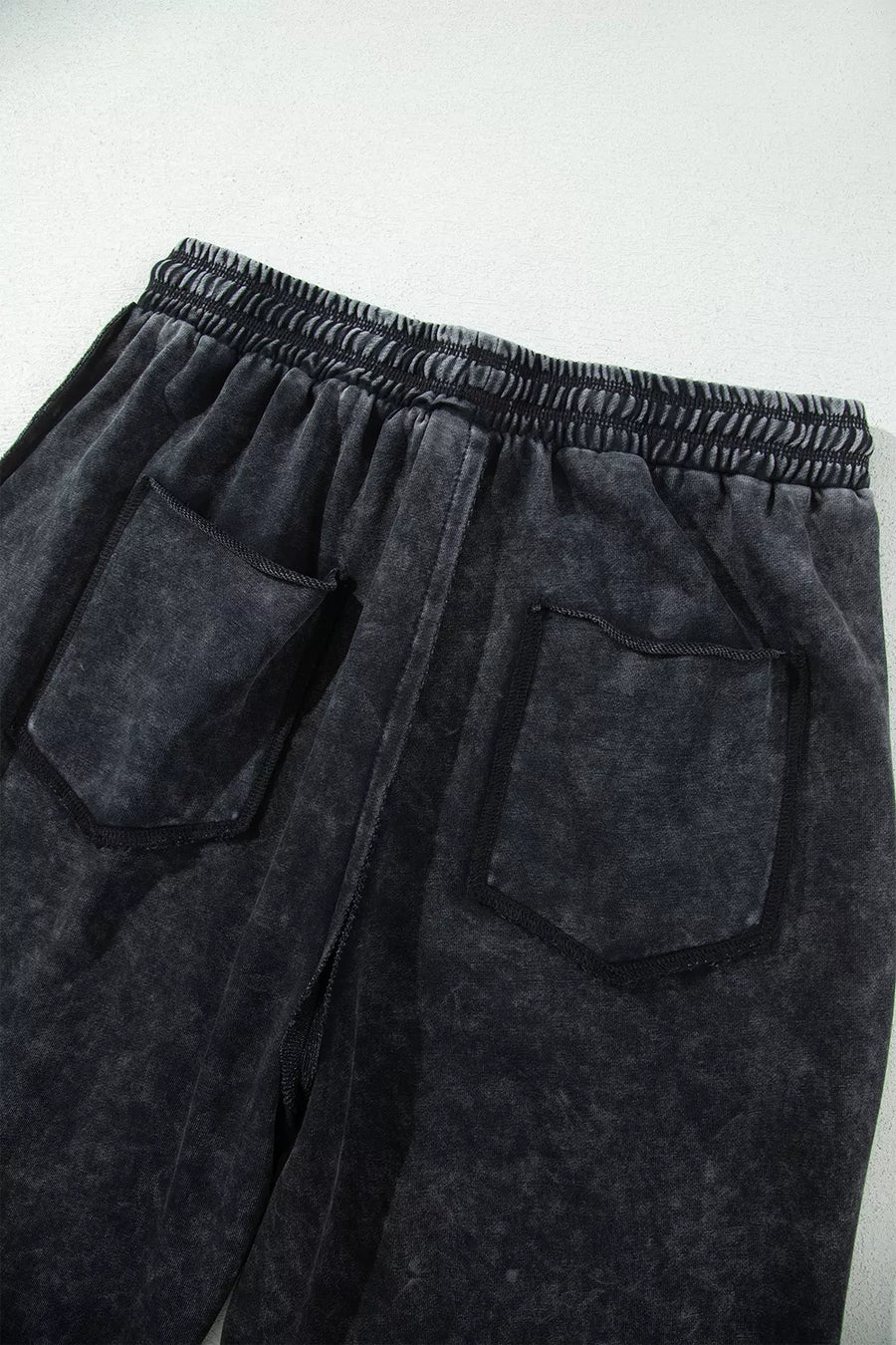 charcoal gray barrel pants with raw seam and N/A