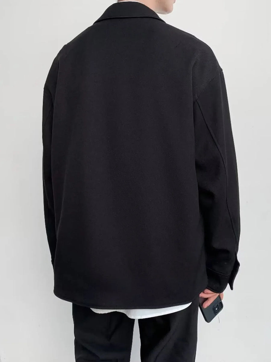 Black oversized button-down jacket with a collar and long sleeves.