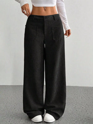 Black corduroy wide-leg trousers with front pockets and a comfortable fit.