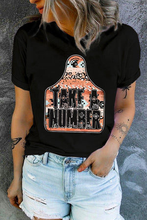 Black graphic t-shirt with Take A Number text on a tag shape with mixed patterns