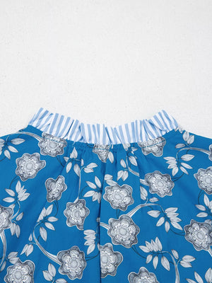 Blue cotton blouse with floral print and ruffled striped neckline