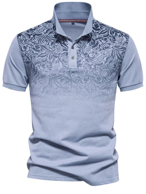 Light blue floral ombre polo shirt with short sleeves and a buttoned collar.
