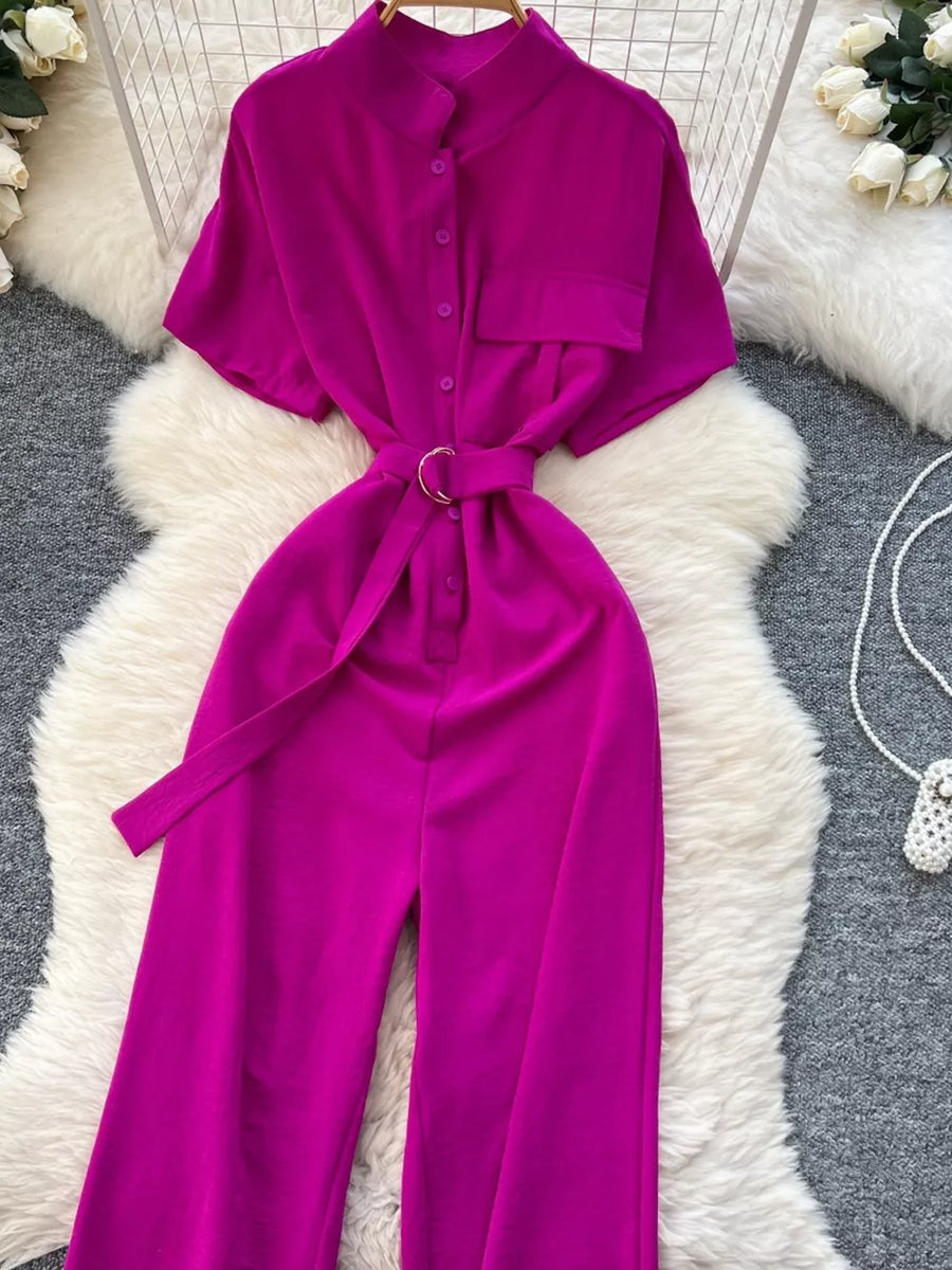 Chic belted wide leg romper in rose red with short sleeves and button-down front.