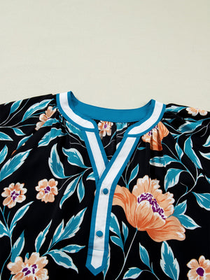Black floral print blouse with bubble sleeves and button-down detail.