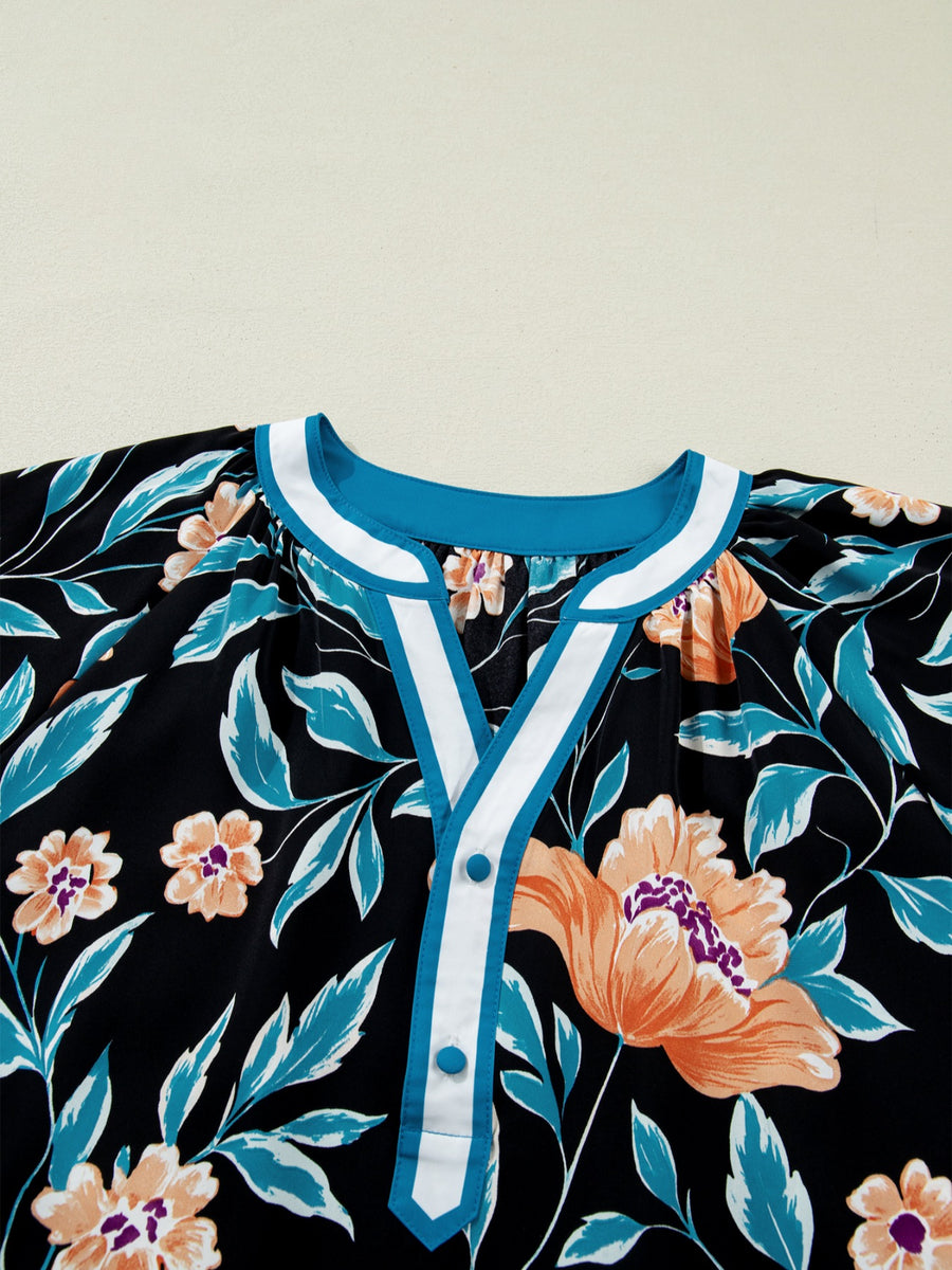 Black floral print blouse with bubble sleeves and button-down detail.