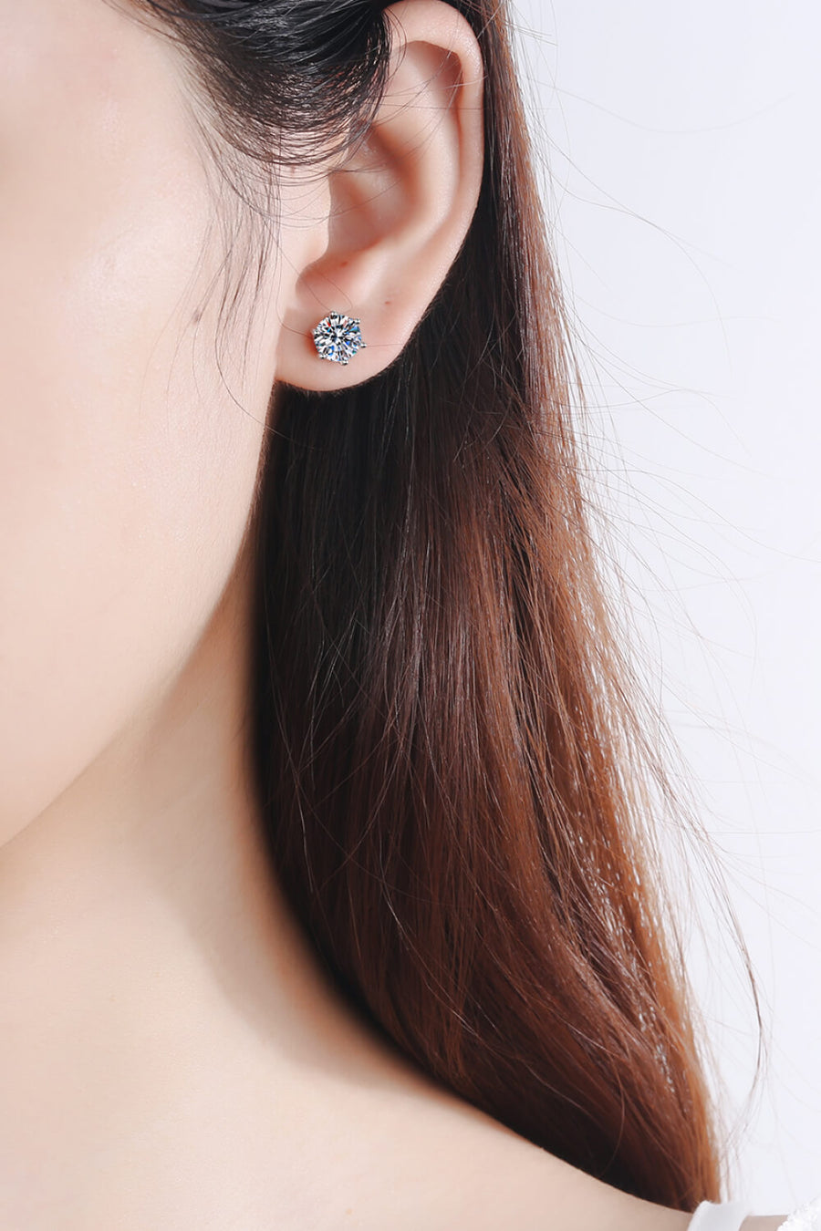 Six-prong moissanite stud earrings in silver, featuring a brilliant cut stone.