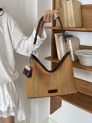 green crossbody bag featuring woven and striped