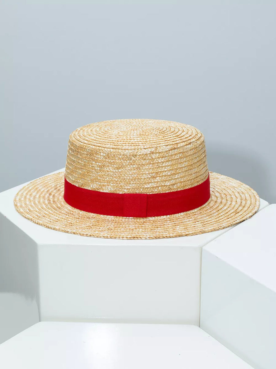 Women's straw boater hat with red ribbon band