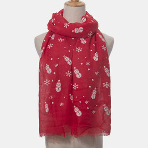 Red scarf with white snowman and snowflake print, fringed edges