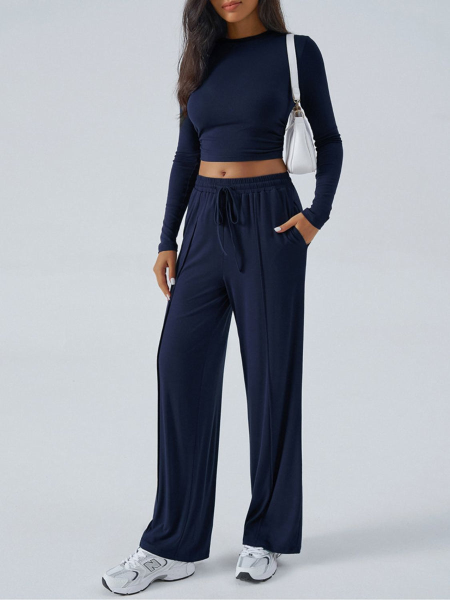 Dark blue ribbed knit crop top and wide leg pants set with drawstring waist and pockets.