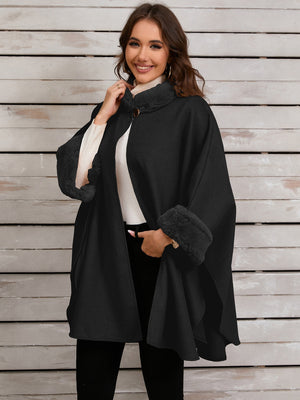 Black cape coat with faux fur trim on collar and cuffs.
