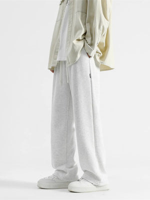 Light gray cotton sweatpants with drawstring and wide legs.