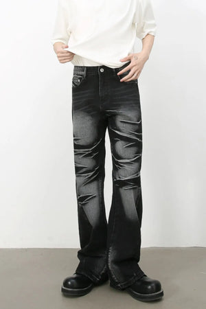 Distressed flare jeans in dark shadow wash denim with a bootcut leg.