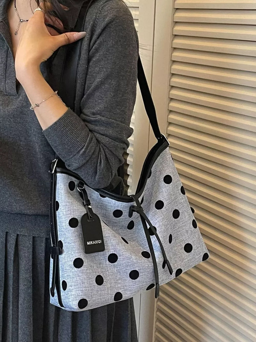 Blue handbag with tie and polka dot