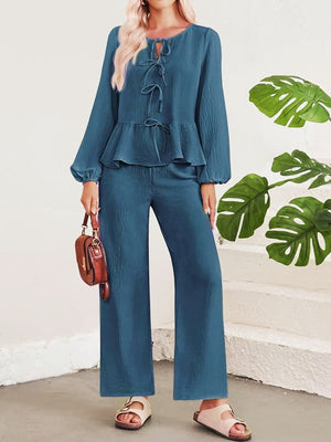 Blue textured peplum top with tie neck and wide leg pants
