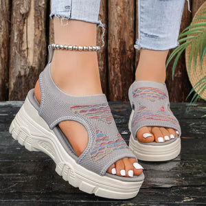 Gray knit platform sandals with colorful geometric pattern and open toe.