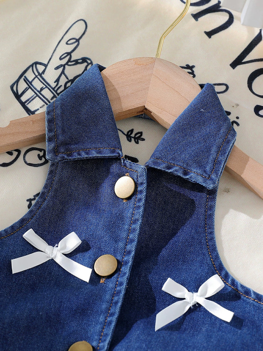 Denim halter top with white bow accents and gold buttons