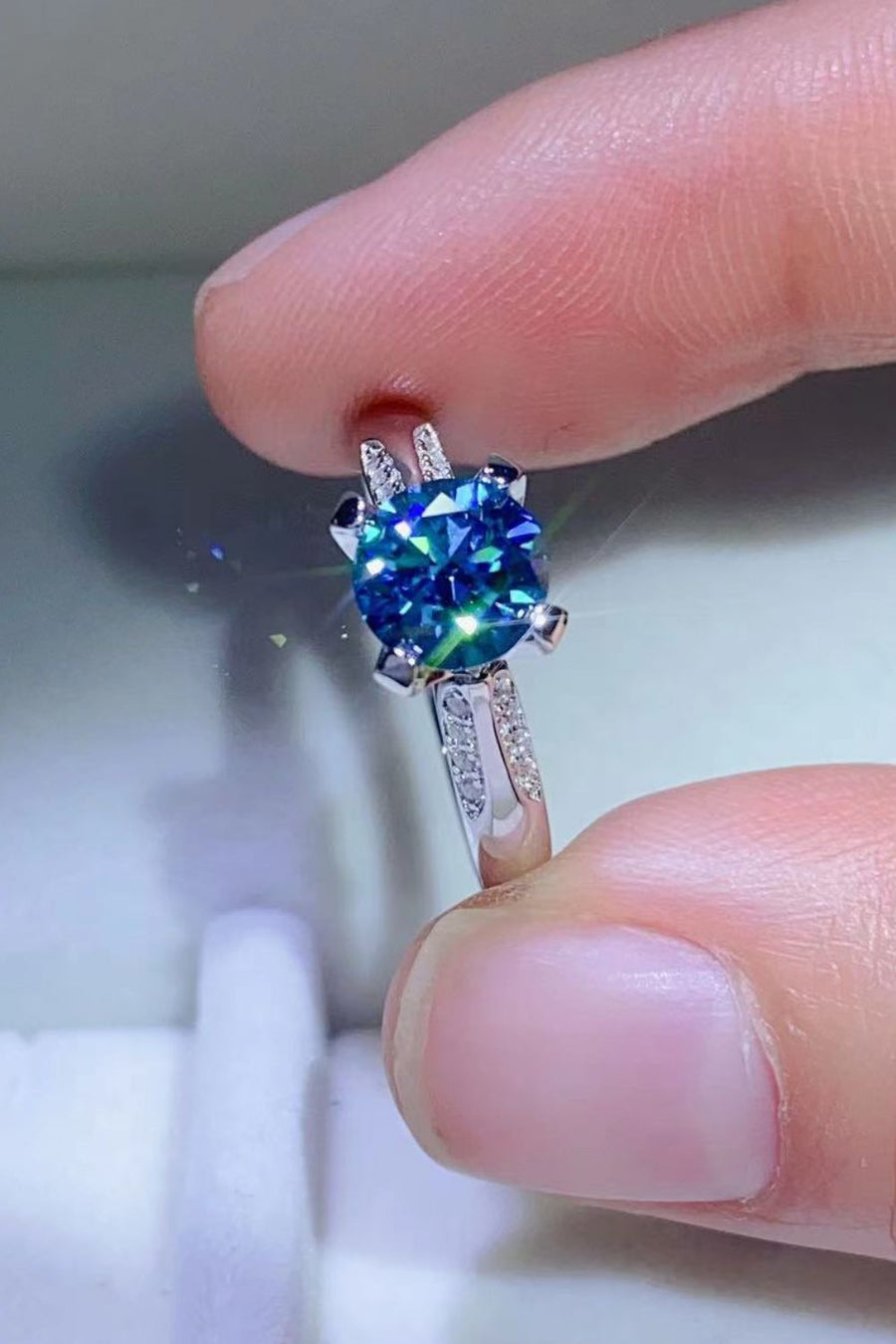 Celestial blue moissanite engagement ring with diamond band
