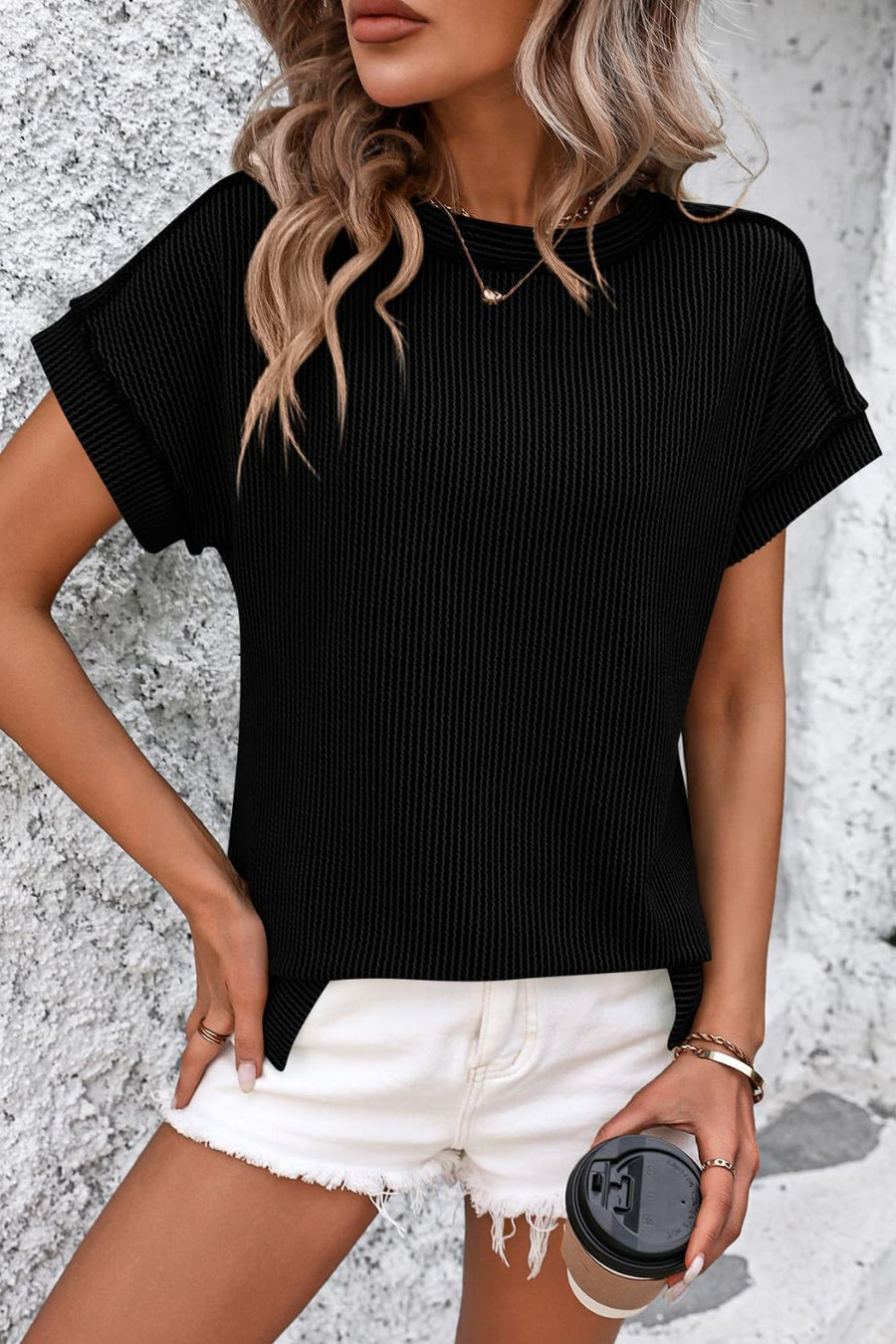 Black vertical ribbed tee with short sleeves and split hem detail