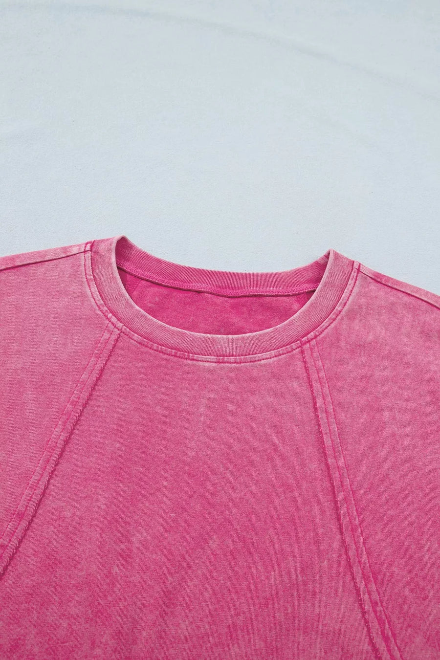 Pink mineral wash t-shirt with cap sleeves and contrast stitching detail.