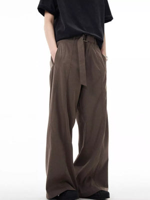 Men's dark brown wide-leg sweatpants with belt detail and pockets.