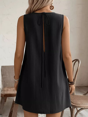 Black sleeveless dress with tie-back detail and pockets