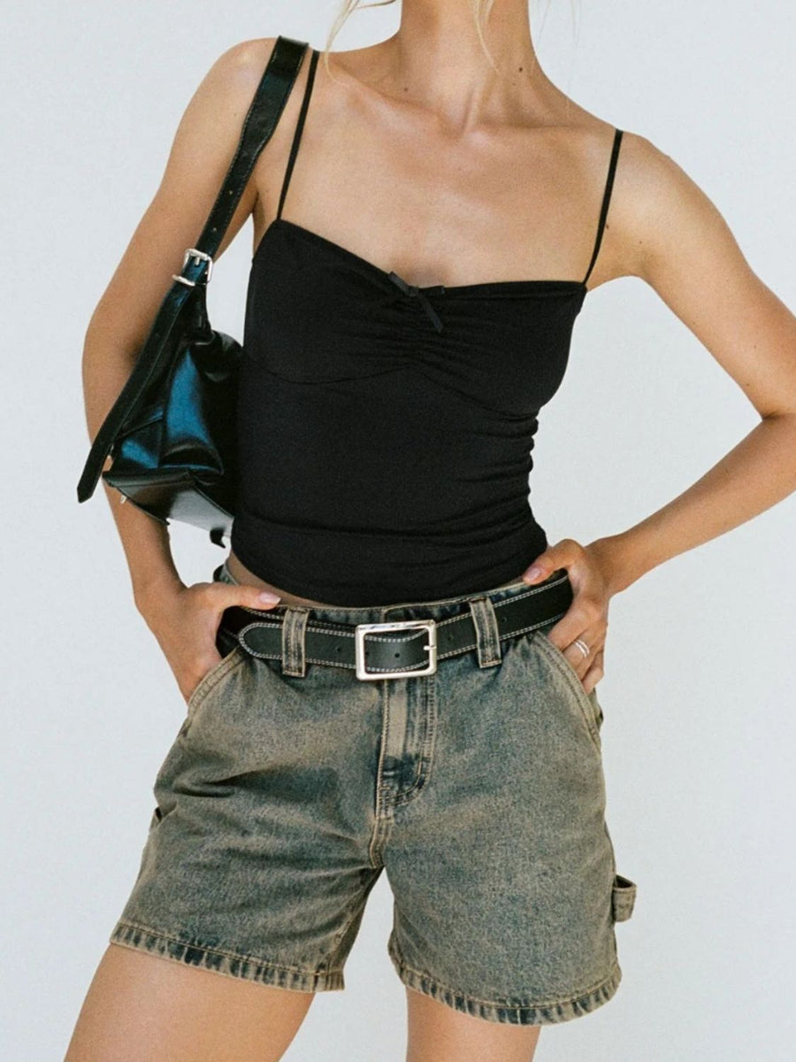 Utility denim carpenter shorts in brass wash with contrast stitching and tool pocket detail.