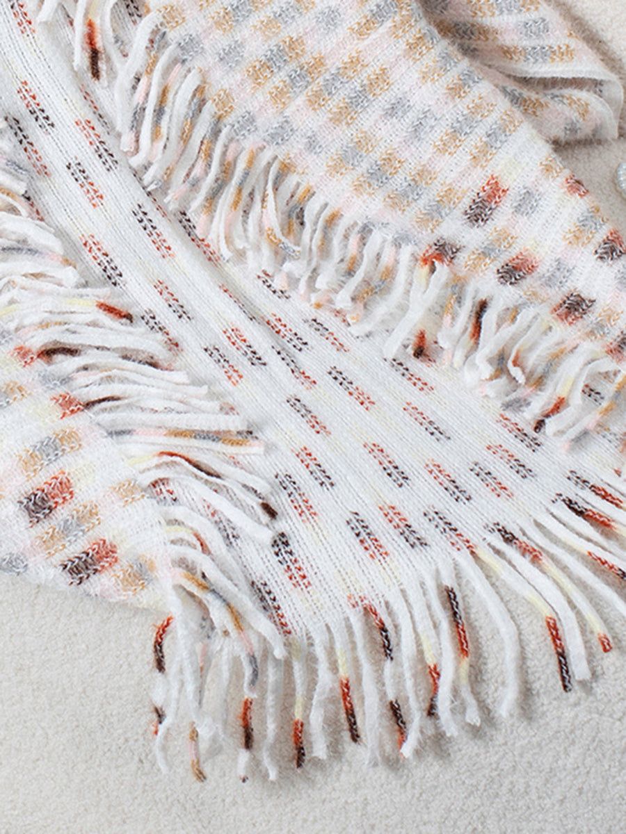 Textured fringe shawl cardigan in white with multicolor woven pattern and fringe details.