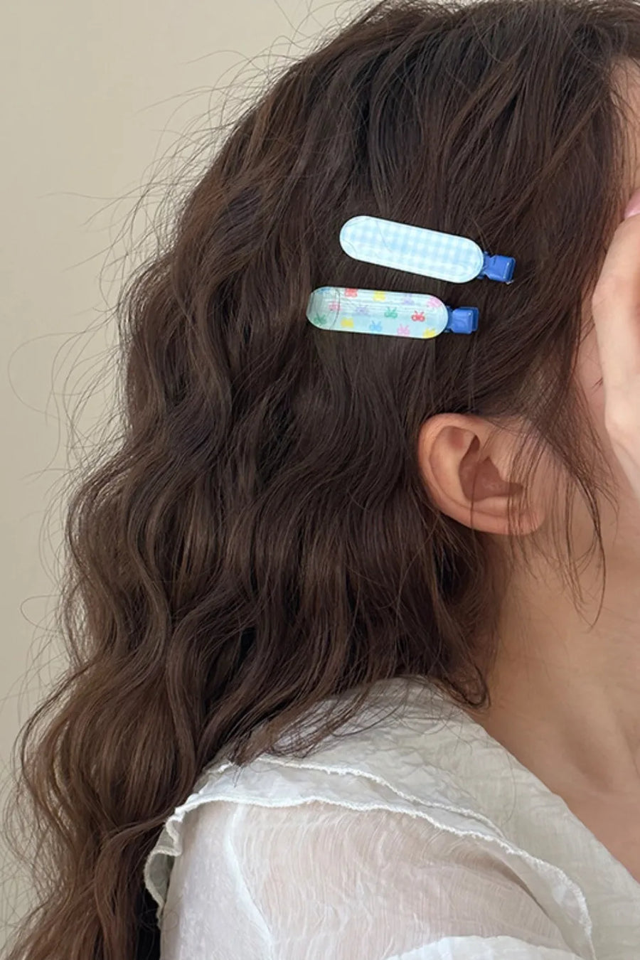 Pastel blue gingham and bunny print hair clips with blue clasps.