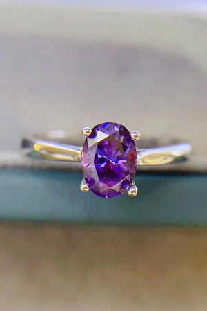 Oval cut amethyst solitaire ring with silver band