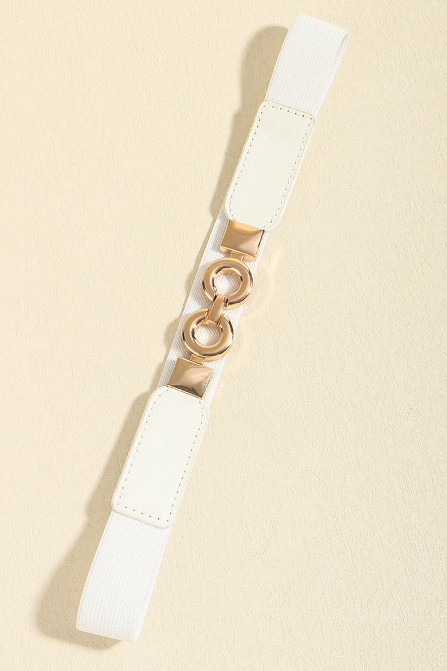 White elastic belt with gold interlocking rings and square buckle detail